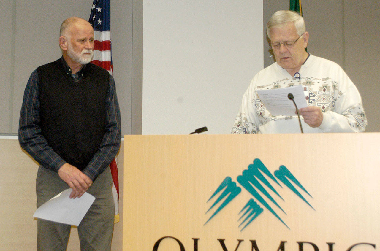 Thomas Hightower, left, is congratulated by Olympic Medical Center board chairman John Beitzel for being selected as a District 3, Position 1 commissioner. Hightower will be sworn in Feb. 7. (Rob Ollikainen/Peninsula Daily News)