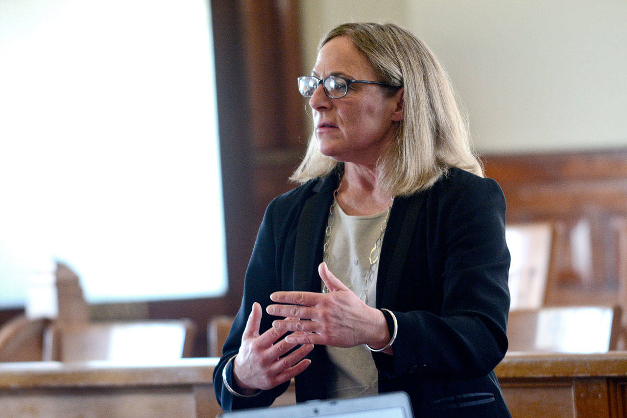 Patricia Charnas, director of the county Department of Community Development, discusses the draft development agreement for a resort near Brinnon on Tuesday. (Jesse Major/Peninsula Daily News)