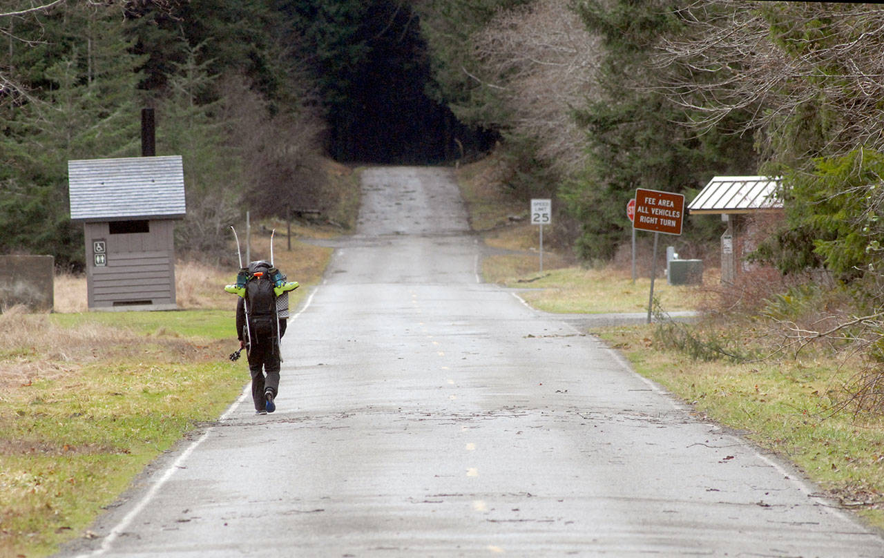 A lone hiker walks up Olympic Hot Springs Road in Olympic National Park on Saturday. Although the road had been previously barricaded because of storm damage, the park was officially closed on Saturday as a result of a federal government shutdown, but many areas remained accessible. (Keith Thorpe/Peninsula Daily News)