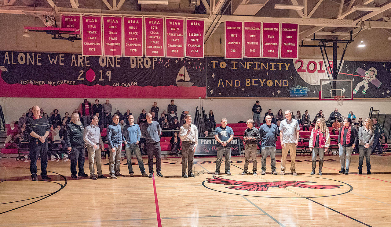 Players, coaches and cheerleaders from the 1992-93 Port Townsend basketball team are honored for their achievement 25 years after taking second at the Class A state tournament during halftime of a game between the Redhawks and the Klahowya Eagles on Friday. (Steve Mullensky/for Peninsula Daily News)