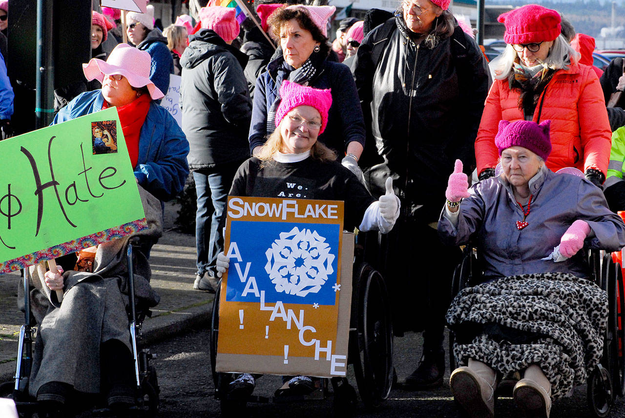 Pink hats were part of the wardrobe for the Port Townsend Women’s March. The weather started out with sun, but turned cloudy with brisk winds and cold temperatures during the speeches. (Jeannie McMacken/for Peninsula Daily News)