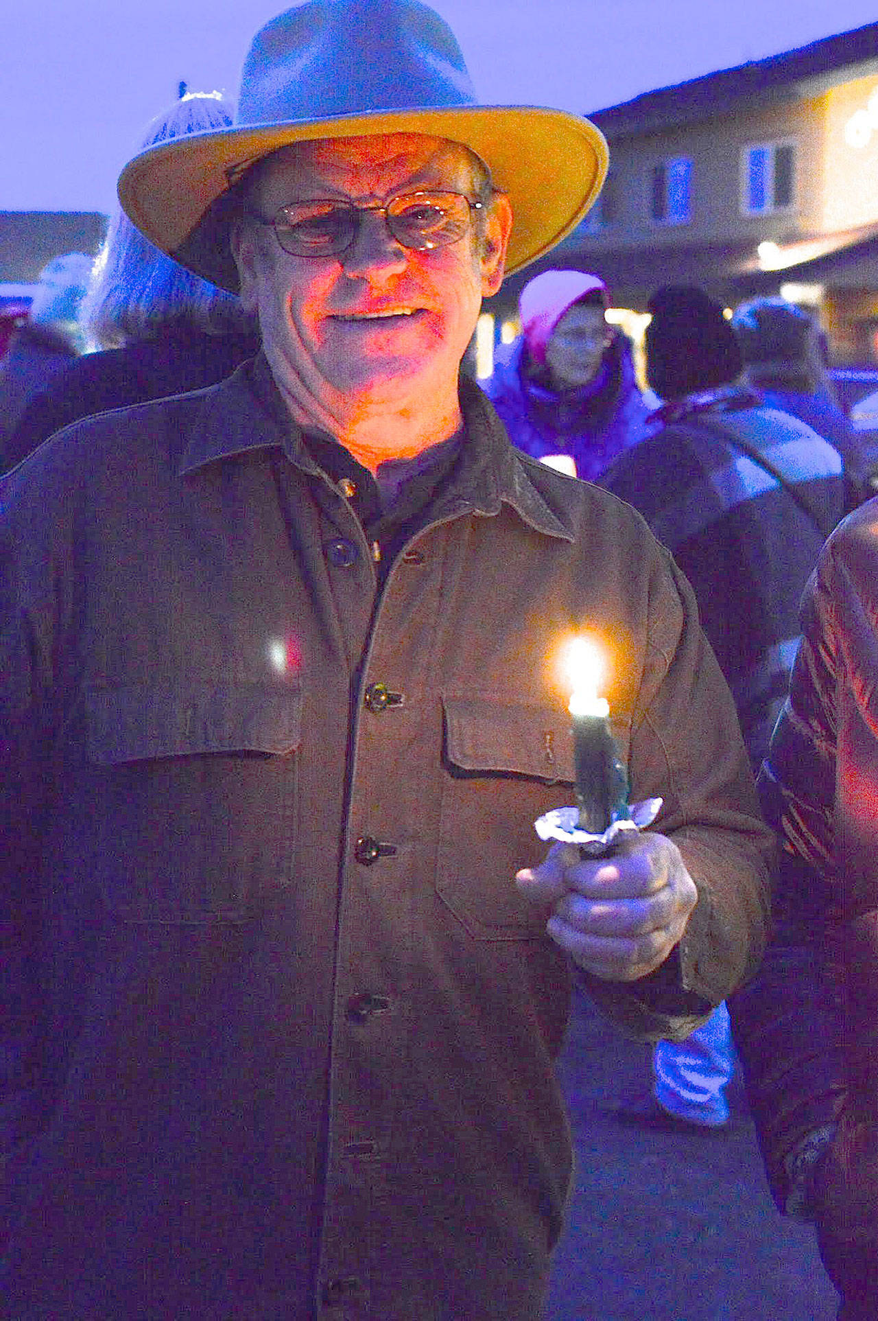 Sequim resident Dan Long was among the candle carriers in a vigil held Saturday in downtown Sequim. (Diane Urbani de la Paz/for Peninsula Daily News)
