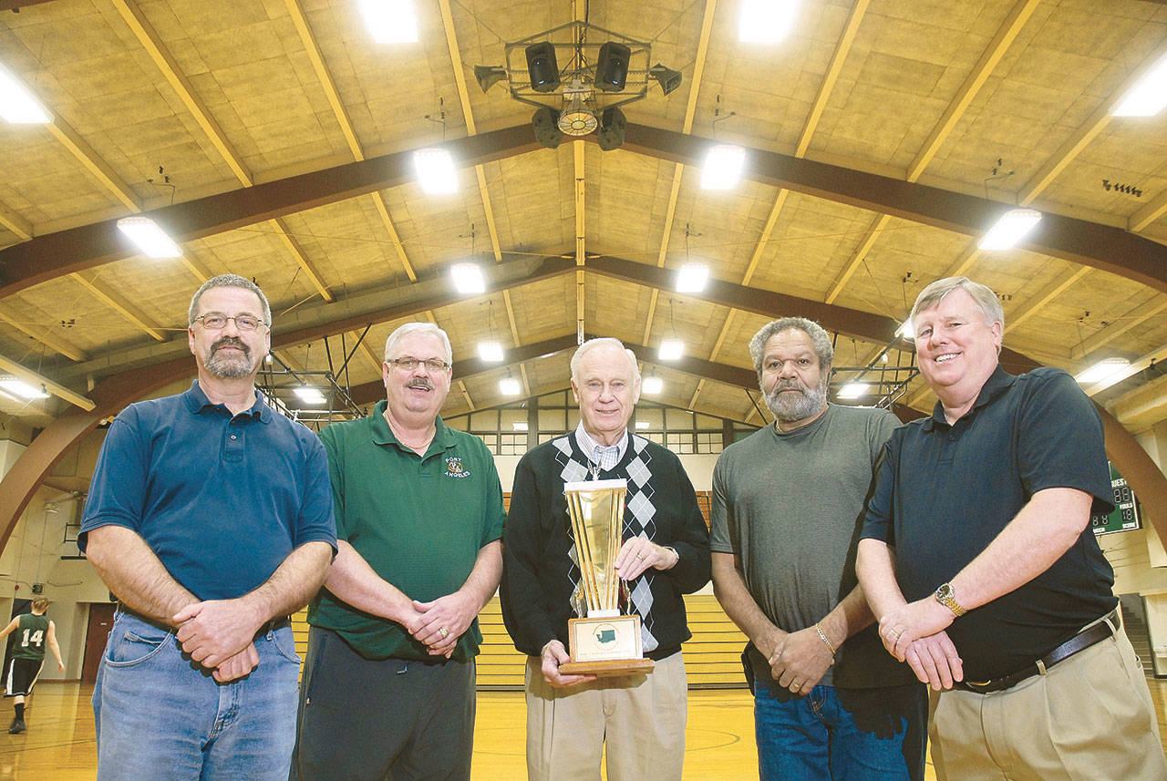 Mike Clayton, Leroy Sinnes, Bob Klock, Wiley Duckett and Greg Kushman, from left,hold their 1966 second-place state tournament trophy at the Port Angeles High School gymnasium in 2011. (Peninsula Daily News)