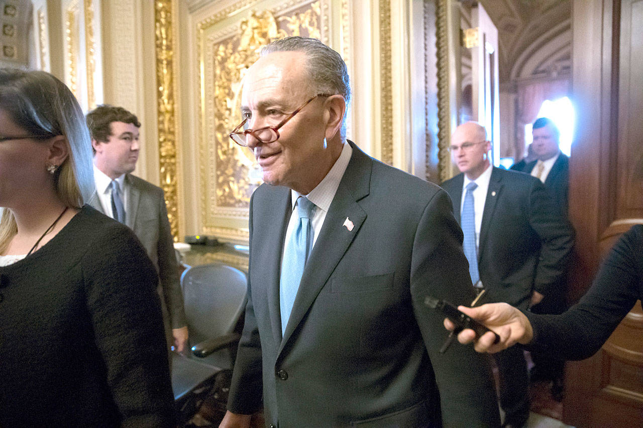 Senate Minority Leader Chuck Schumer, D-N.Y., heads to the chamber with fellow Democrats for a procedural vote aimed at reopening the government, at the Capitol in Washington, D.C., on Monday. (J. Scott Applewhite/The Associated Press)