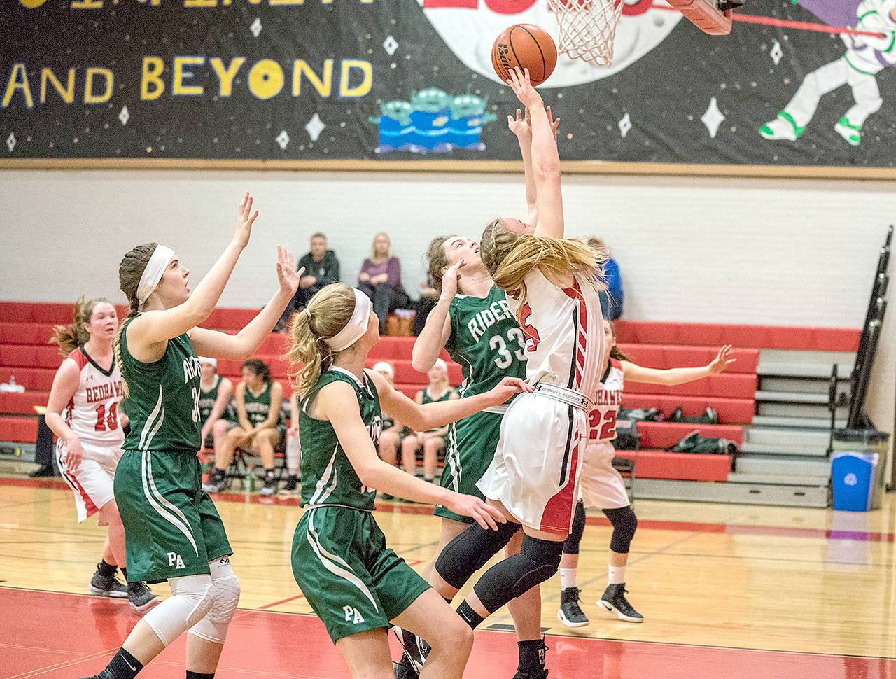 Port Townsends Kaitlyn Meek, right, goes up for a basket while surrounded by Port Angeles Roughriders, from left, Devin Edwards, Emilia Long and Jaida Wood.                                Steve Mullensky/for Peninsula Daily News