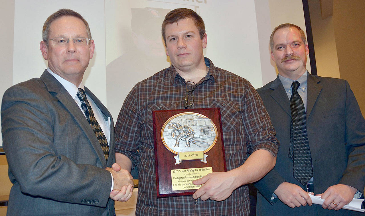 Chief Sam Phillips presents Ian Brueckner with the Career Firefighter of the Year award. Left to right Chief Sam Phillips, firefighter/paramedic Ian Brueckner and Deputy Chief Jake Patterson. (Jay Cline/Clallam County Fire District 2)
