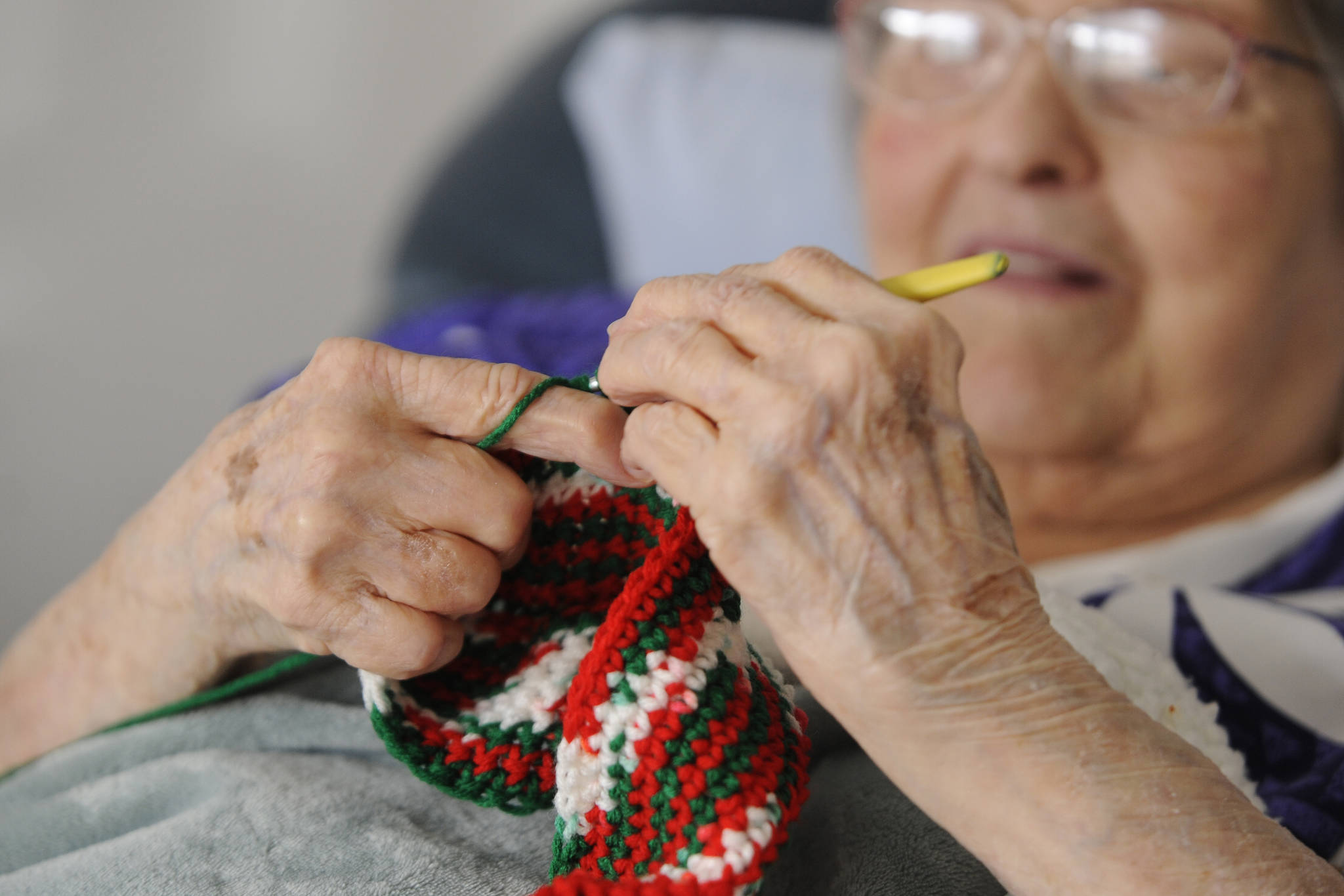 Phyllis Peashka says she taught herself to crochet. She figures she makes at least one hat, scarf or potholder per day. “My hands cramp up, but I keep going.” (Michael Dashiell/Olympic Peninsula News Group)