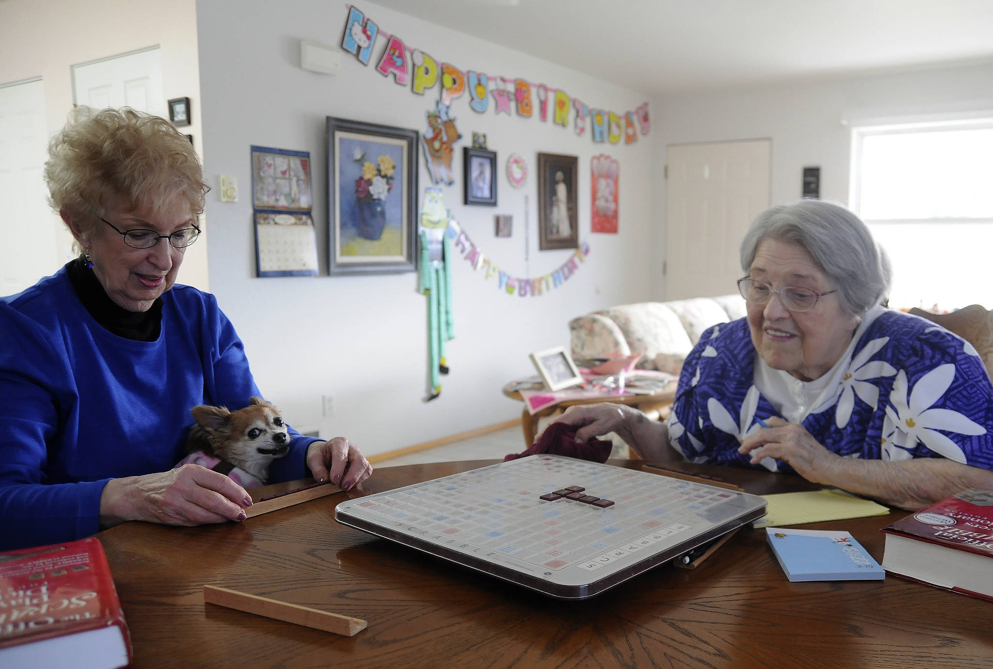 Sally Harris-Crawford and Phyllis Peashka start one of their weekly Scrabble games last week. Peashka recently turned 96. (Michael Dashiell/Olympic Peninsula News Group)