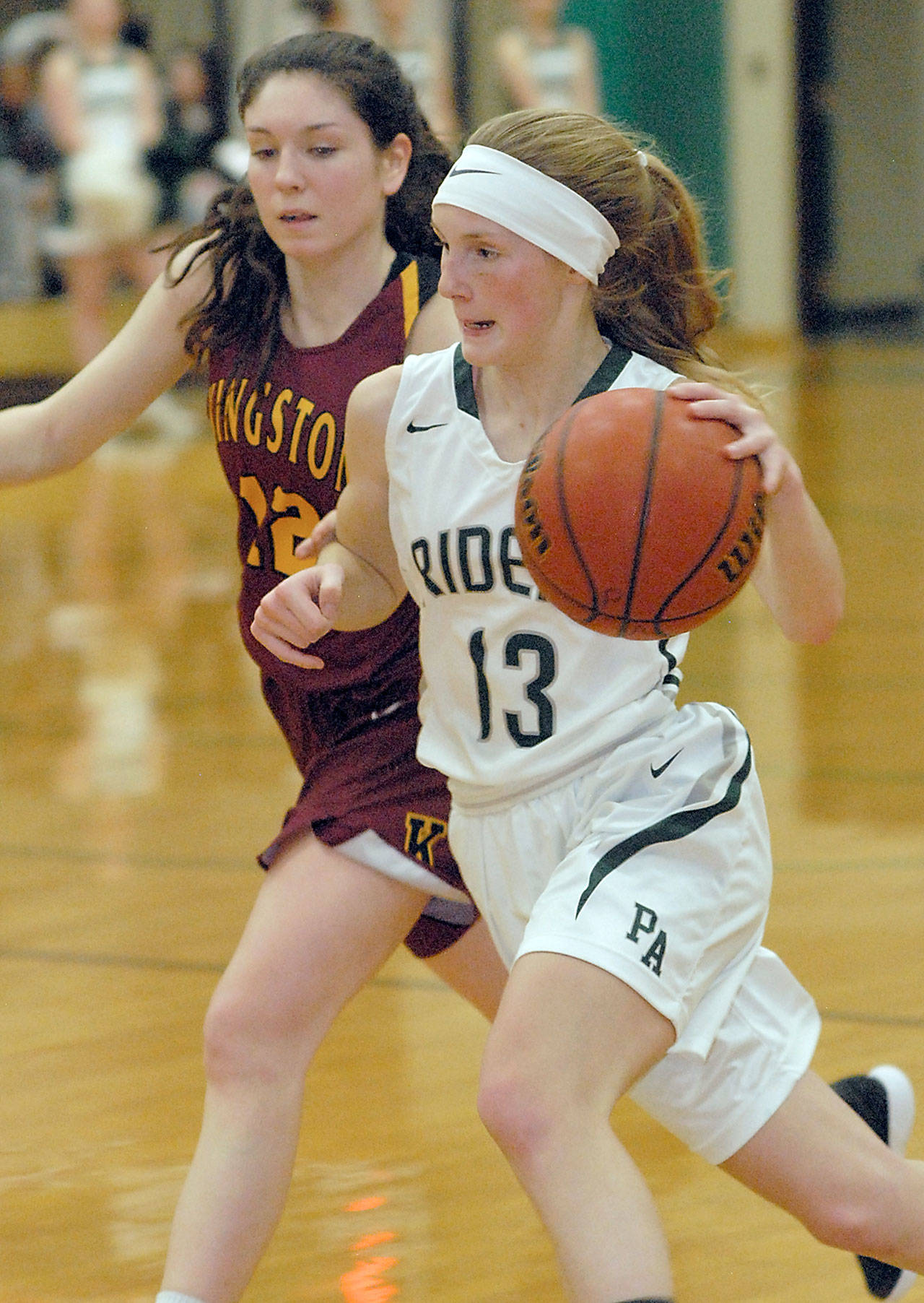 Keith Thorpe/Peninsula Daily News Port Angeles’ Millie Long sweeps past Kingston’s Lily Beaulieu in the second quarter on Friday night at Port Angeles High School.