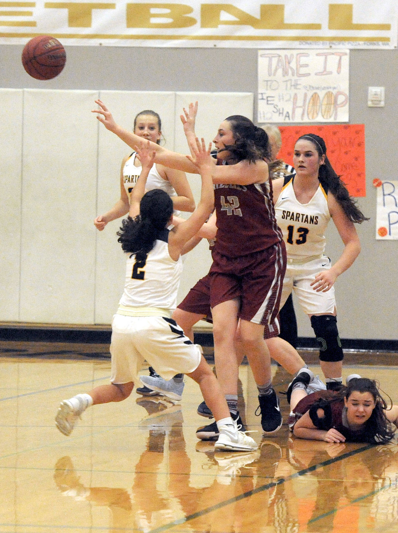 Forks’ Iesha Johnson (2) Chloe Leverington (21) and Rian Peters (13) attempt to trap Hoquiam’s Rylee Vonhof (42) during the Spartan’s 55-54 win.                                Lonnie Archibald/for Peninsula Daily News