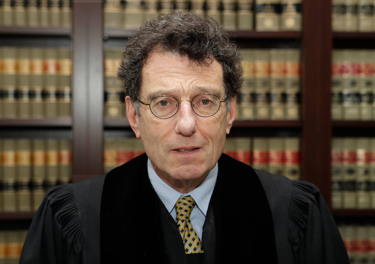 Judge Dan Polster in his office in Cleveland on Jan. 11. Polster has called the opioid addiction epidemic “100 percent man-made” and asserted that other branches of government have “punted” on solving it. Polster has made clear that he wants to use the cases before him as a way to forge a solution to the opioid crisis — not just a legal resolution. (Tony Dejak/The Associated Press)