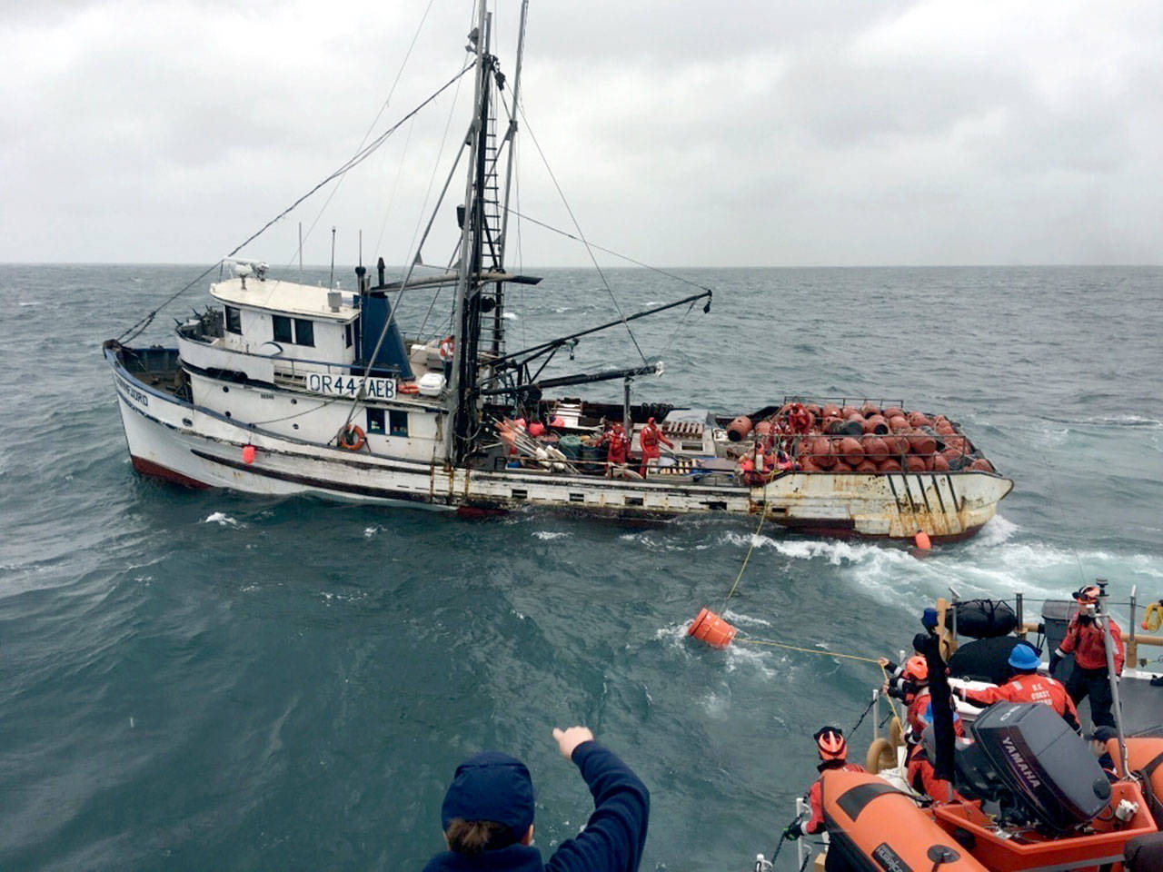 The crew of the Coast Guard Cutter Cuttyhunk pass two dewatering pumps to the crew of the fishing vessel Sunnfjord as their vessel took on water off Cape Alava, Wash., Jan. 31, 2018. Unable to start either pump or keep up with the rising water, the fishermen eventually abandoned ship. (Petty Officer 2nd Class Alexander Warriner/U.S. Coast Guard)