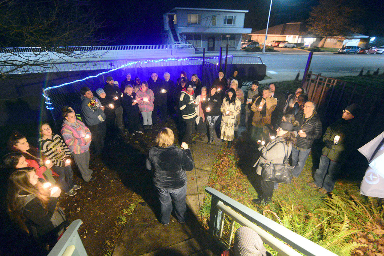 A crowd gathers on the east side of the Valley Creek Eighth Street bridge Wednesday evening to mourn community members who have taken their own lives and to raise awareness about suicide. (Jesse Major/Peninsula Daily News)