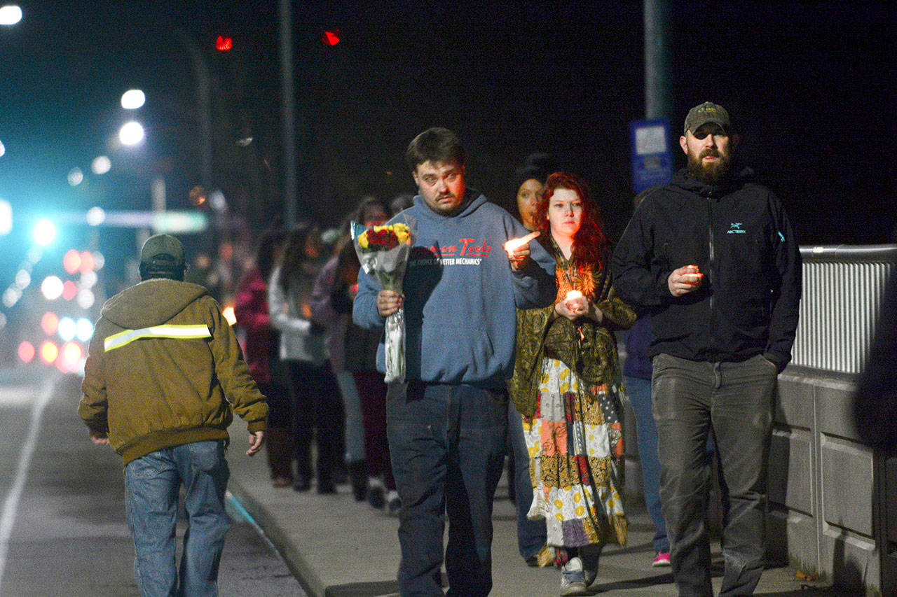 Dozens carrying candles walked the span of the Valley Creak Eighth Street Bridge in Port Angeles Wednesday during a vigil mourning community members who have committed suicide. (Jesse Major/Peninsula Daily News)