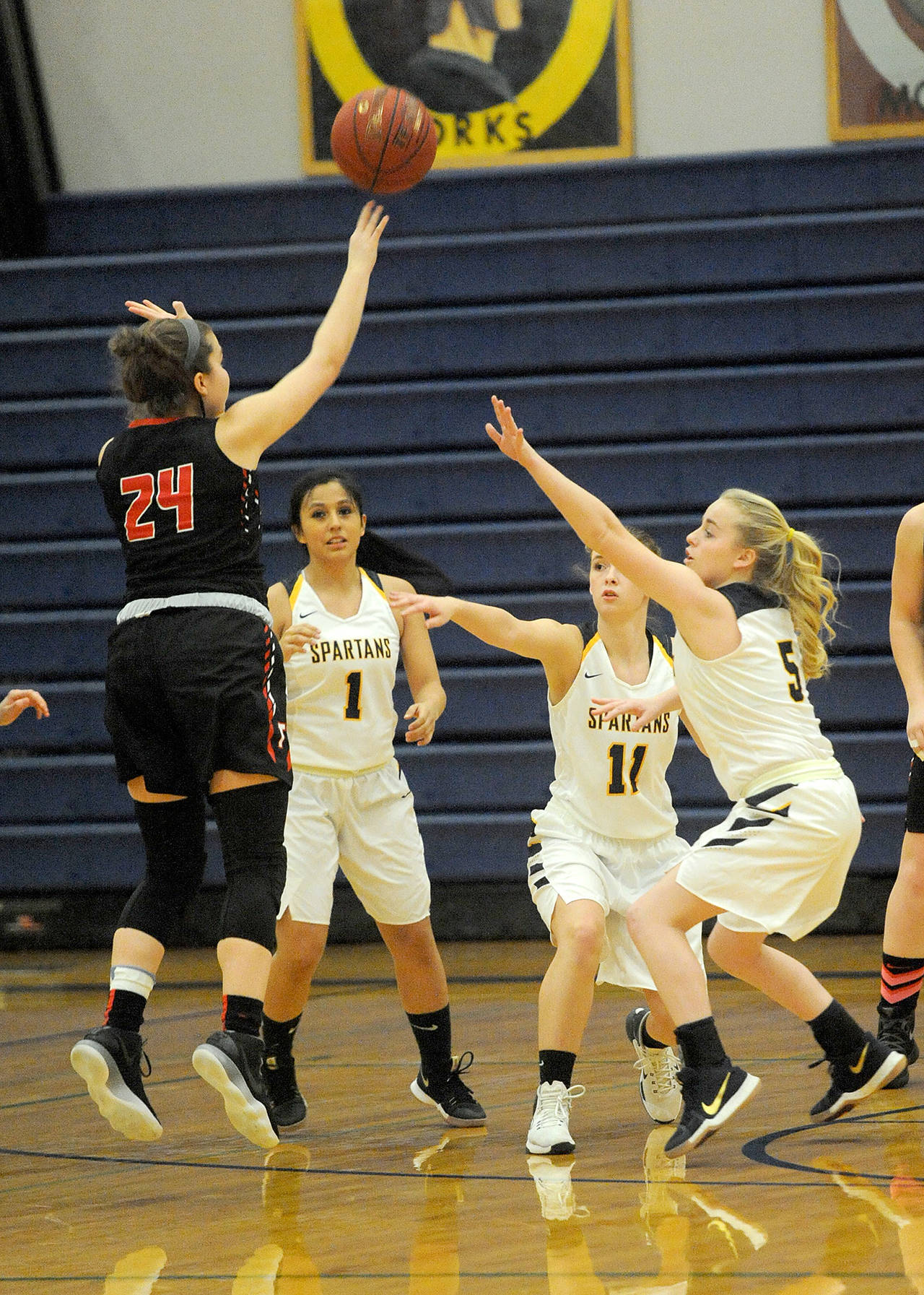 Lonnie Archibald/for Peninsula Daily News Forks seniors from left, Cassandra Vasquez, Sage Baar and Bailee kratzer defend against Tenino’s Kaylee Schow during the Spartans’ 42-30 senior night victory.