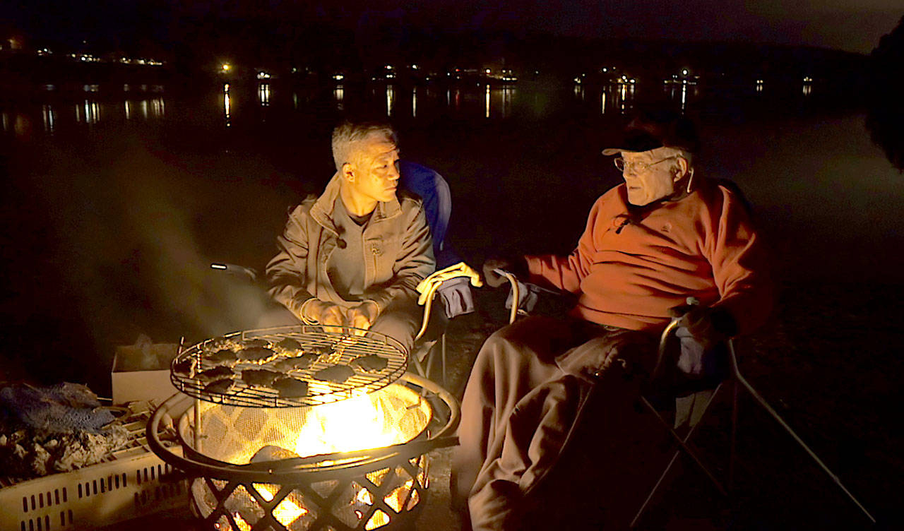 Jerry Yamashita, 95, relates the family history to son Patrick over their oyster farming tidelands.