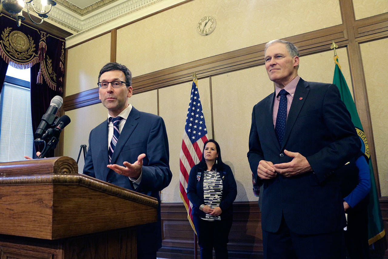 Washington Attorney General Bob Ferguson, left, speaks to the media about the states opposition to the Trump administrations proposal to expand offshore drilling, as Gov. Jay Inslee looks on, Monday in Olympia. (Rachel La Corte/The Associated Press)