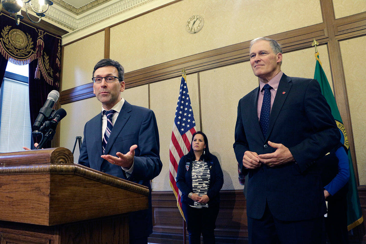 Washington Attorney General Bob Ferguson, left, speaks to the media about the state’s opposition to the Trump administration’s proposal to expand offshore drilling, as Gov. Jay Inslee looks on, Monday in Olympia. (Rachel La Corte/The Associated Press)