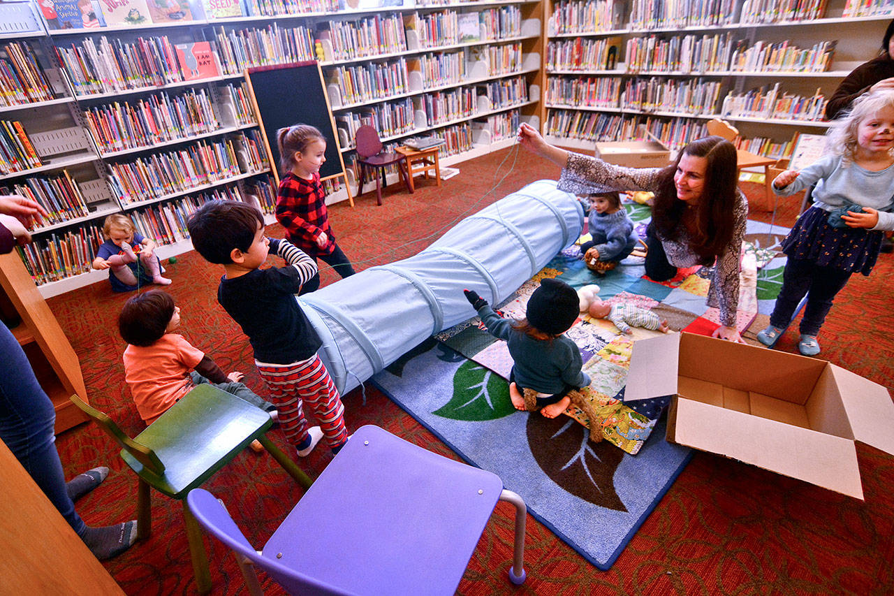 Children play after story time at the Port Townsend Public Library on Tuesday. Officials said that by removing late fees, the library is also making the library more accessible to children. (Jesse Major/Peninsula Daily News)