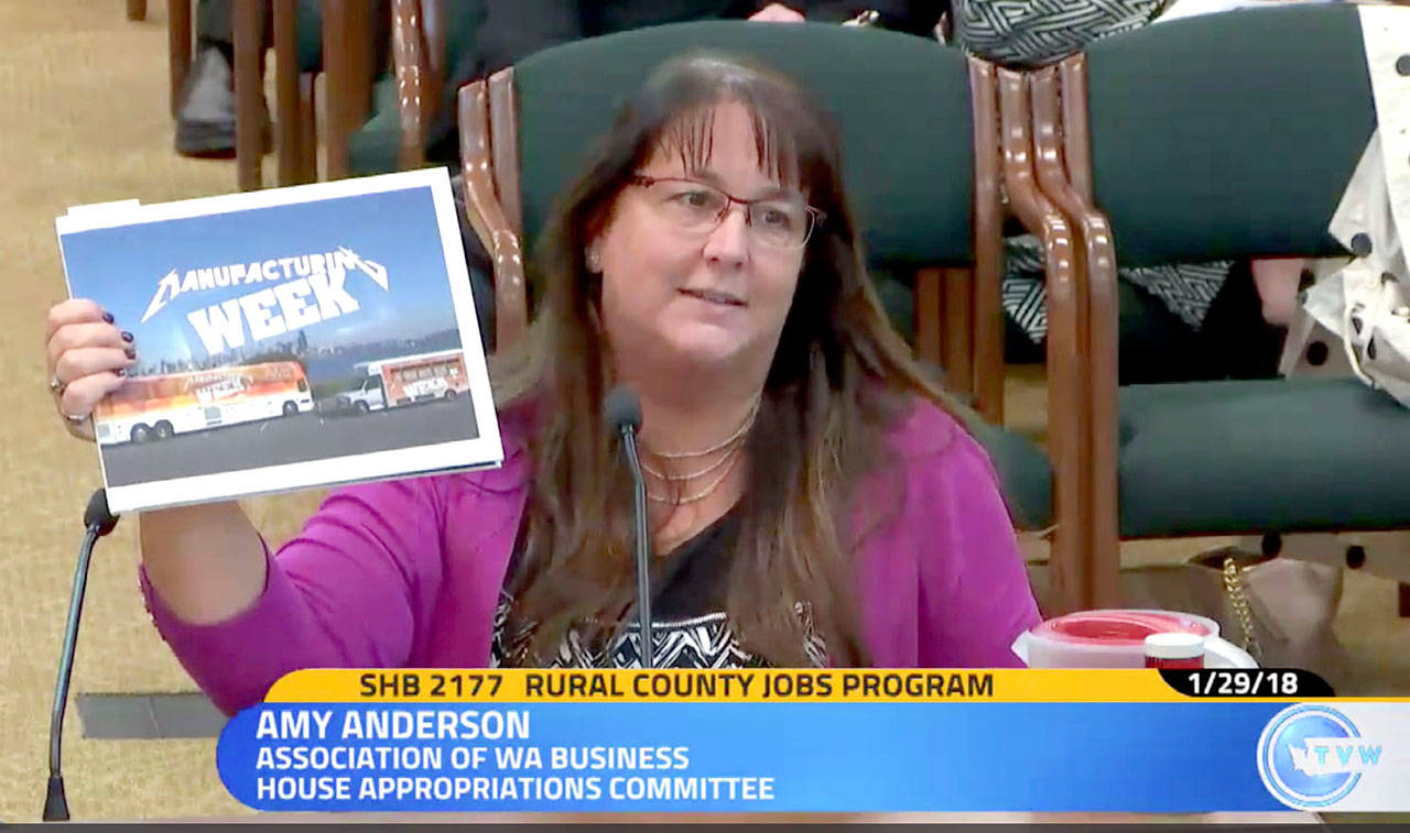 Amy Anderson, government affairs director of the Association of Washington Businesses, shows lawmakers the association’s review of 70 Washington manufacturers at the hearing for HB 2177. She said every industry expressed a need for skilled workers. (Screenshot courtesy of TVW)