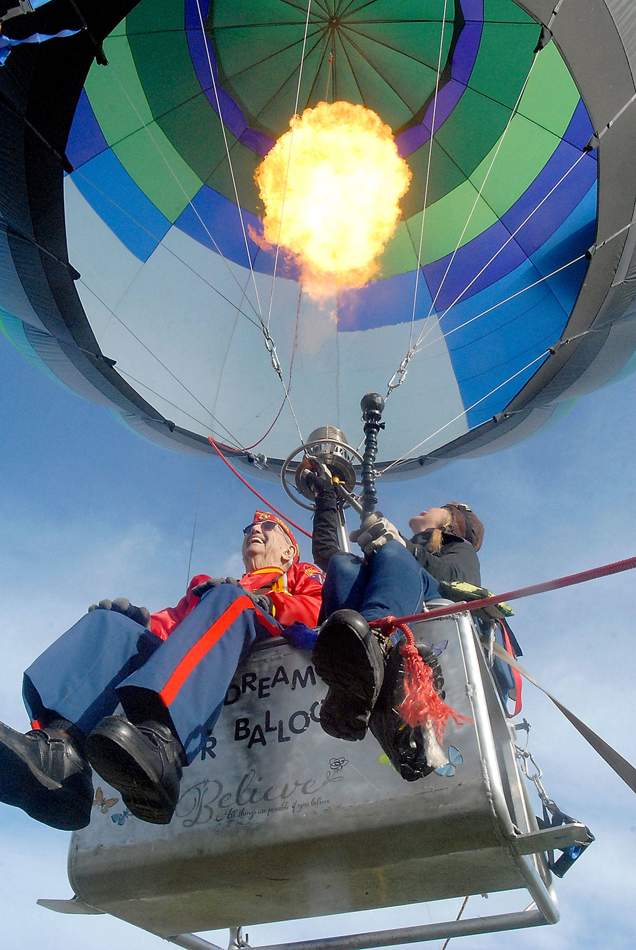Port Angeles resident Tom McKeown, 95, a U.S. Marine Corps veteran of World War II, takes a tethered balloon ride with Capt. Crystal Stout, executive director of Dream Catcher Balloon, on Saturday at Sequim Valley Airport west of Sequim. (Keith Thorpe/Peninsula Daily News)