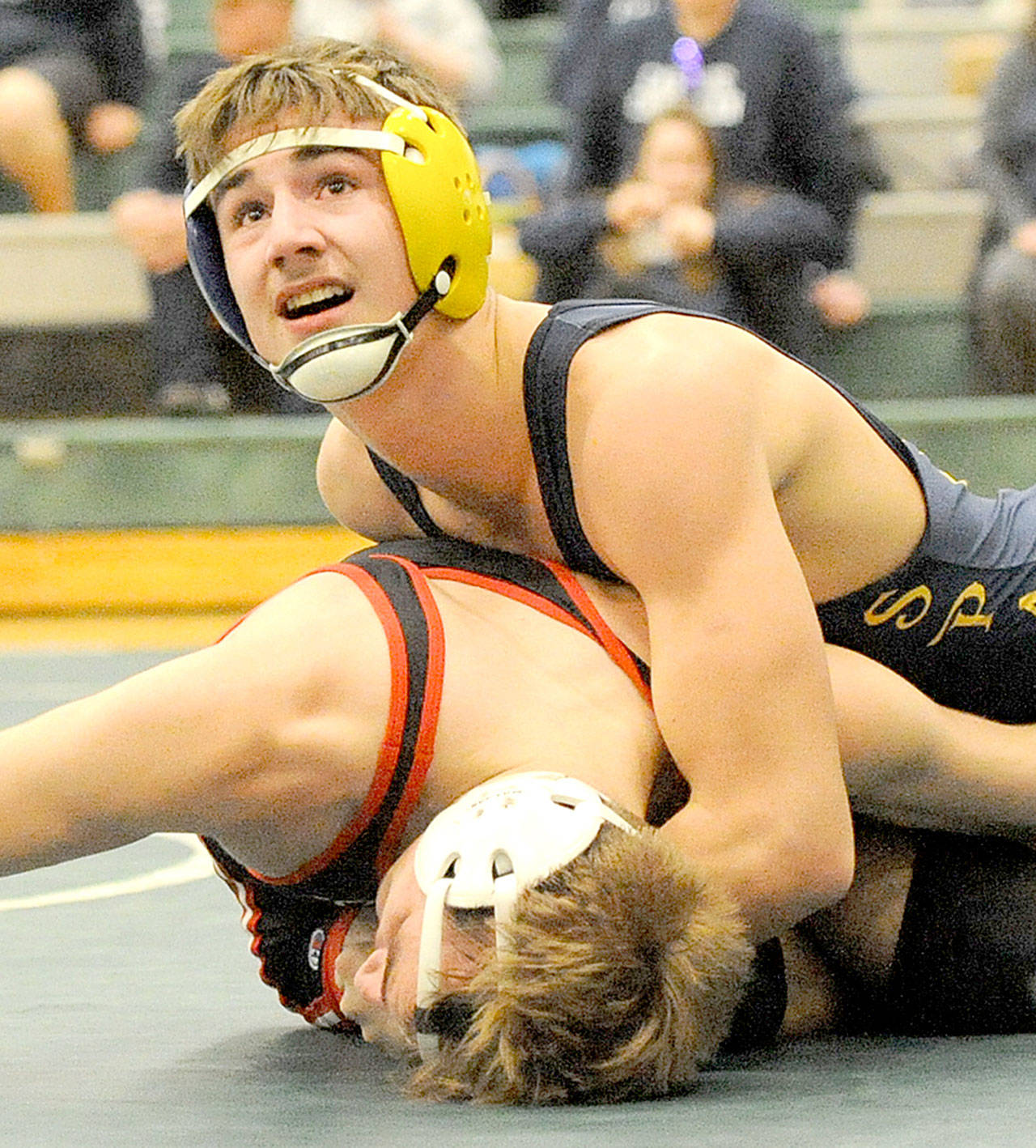 Forks’ Colby Demorest wrestles for the 160-pound championship in the Region 1 meet at Klahowya High School on Saturday. Demorest won the match and will be wrestling at the Mat Classic next weekend. (Lonnie Archibald/for Peninsula Daily News)