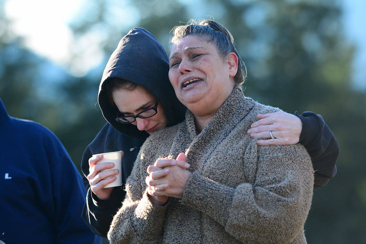 Tanya Orton, left, comforts Roxann Anderson as she pleas for any information that would lead to her 16-year-old niece Bailey Scotts return home during a rally in Quilcene on Sunday. (Jesse Major/Peninsula Daily News)