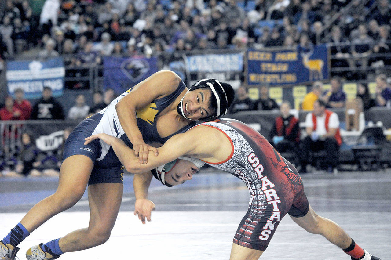 Lonnie Archibald/for Peninsula Daily News Forks’ Josue Lucas defeated Jeremiah Salcedo of Granger in this 106-pound match at Mat Classic, the state wrestling tournament. Lucas, last year’s 106-state champ wrestled Zillah’s Nathanial Mendoza in the finals Saturday night