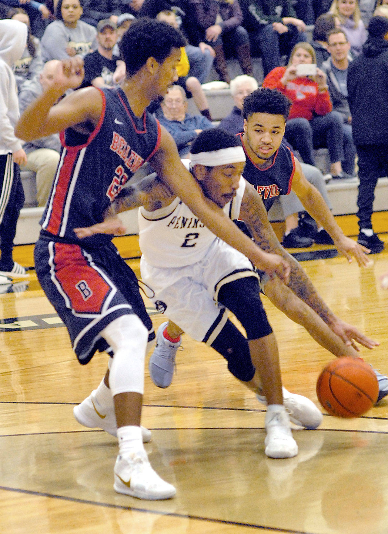 Keith Thorpe/Peninsula Daily News Peninsula’s Cameron Burton, center, drives to the lane around the defense of Everett’s Andrew Shaw, left, and Keannu Royster in the first half of Saturday on the Pirate home court in Port Angeles.