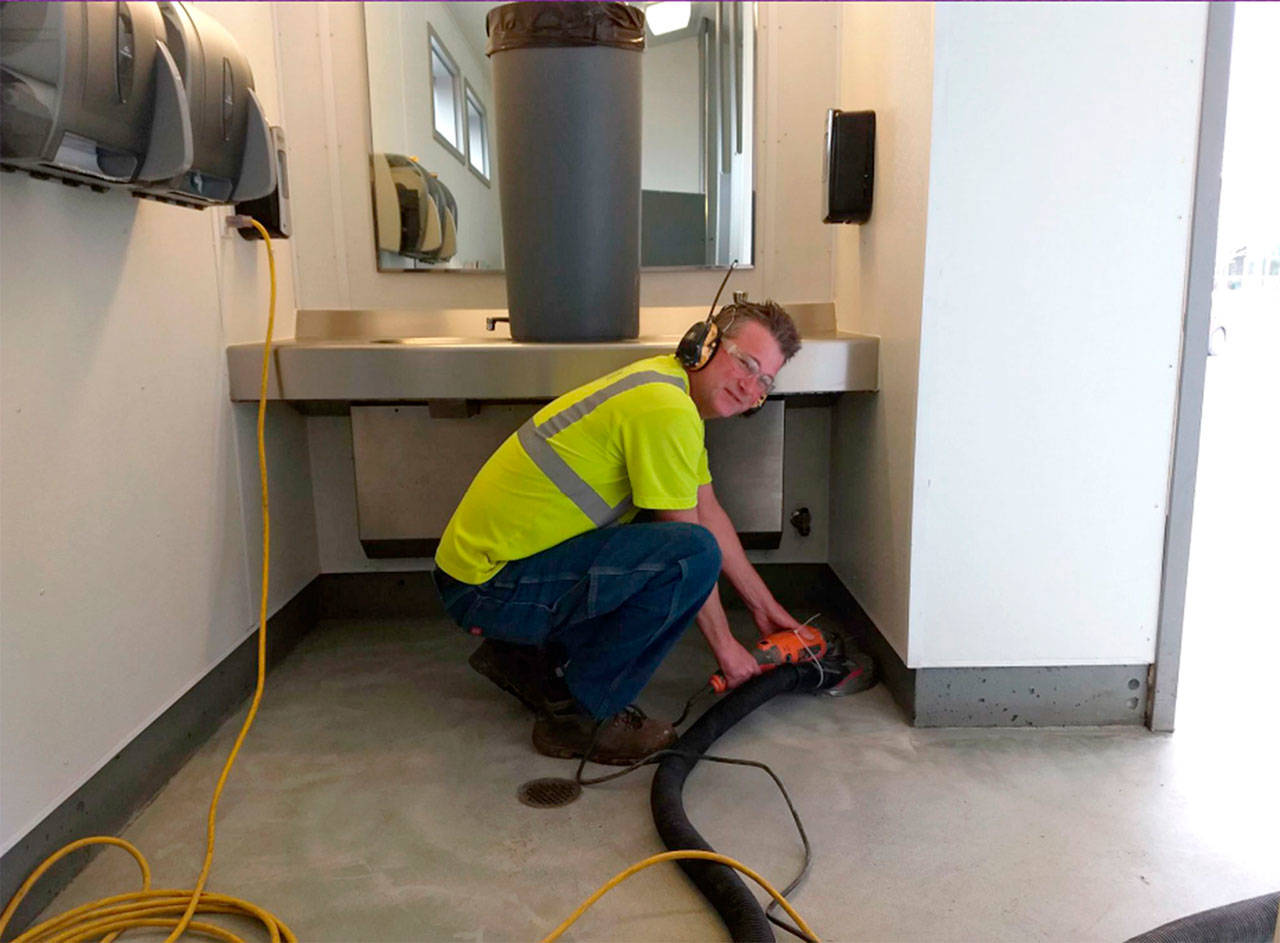 Gary Butler with the city of Sequim works on refurbishing one of the city’s public bathrooms. City staff recently remodeled them to make it easier to clean daily and remove vandalism. (city of Sequim)