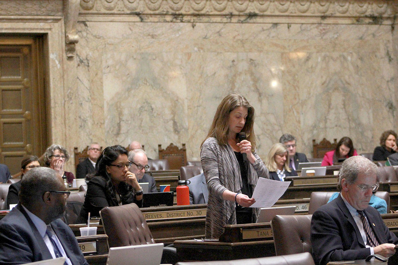 During House floor testimony to ban bump stocks, state Rep. Tana Senn, D- Mercer Island, reads the names of people gunned down at a country music concert in Las Vegas last year. (Taylor McAvoy/WNPA Olympia News Bureau)