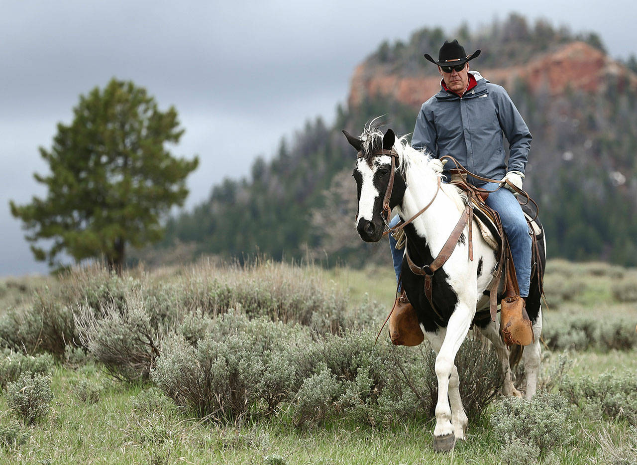 In this May 9, 2017, file photo, Interior Secretary Ryan Zinke takes a horseback ride in the Bears Ears National Monument with local and state representatives in Blanding, Utah. (Scott G Winterton/The Deseret News via AP)