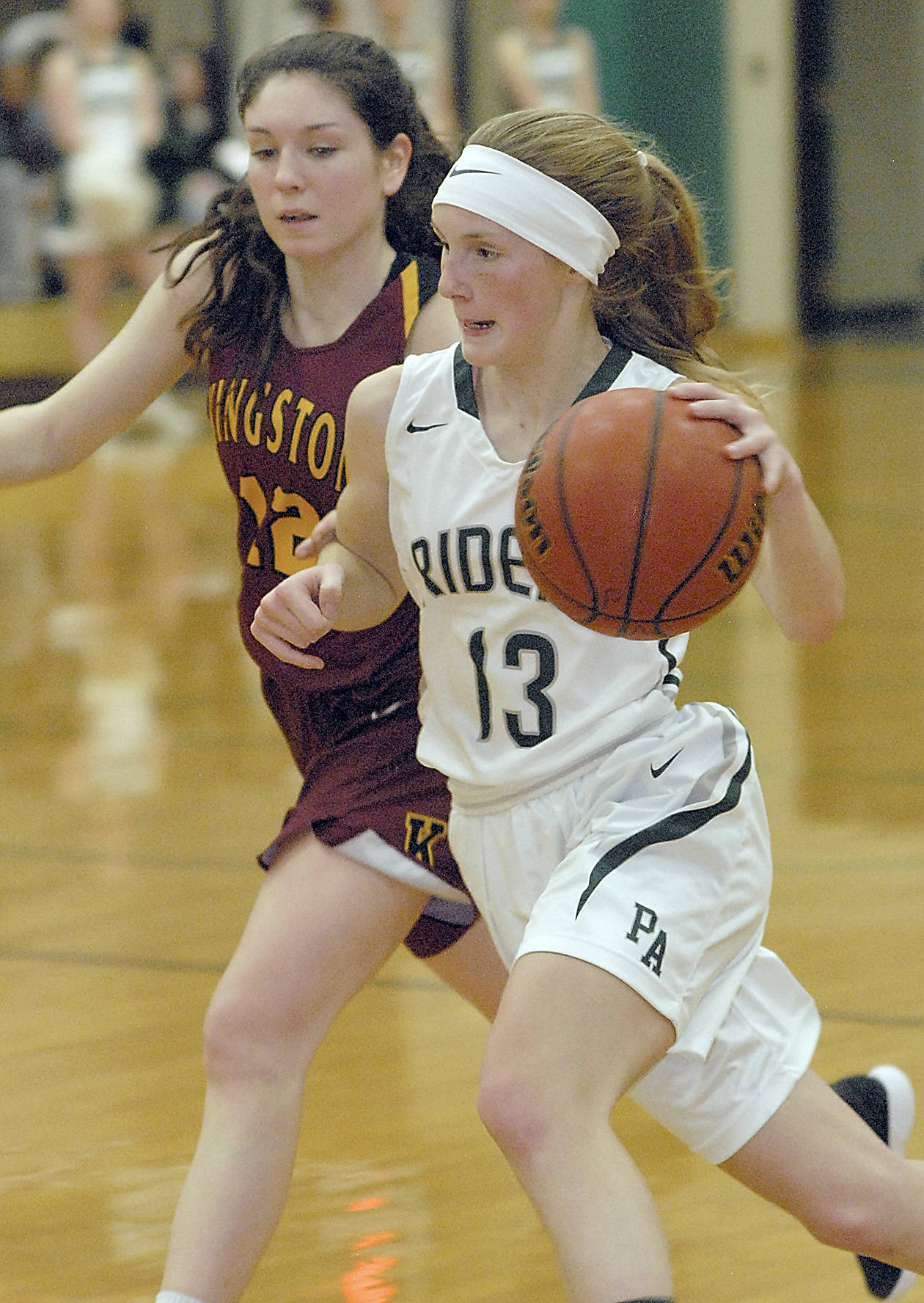 Port Angeles’ Millie Long sweeps past Kingston’s Lily Beaulieu in January at Port Angeles High School. Long, just a freshman, was named Olympic League 2A Division MVP.