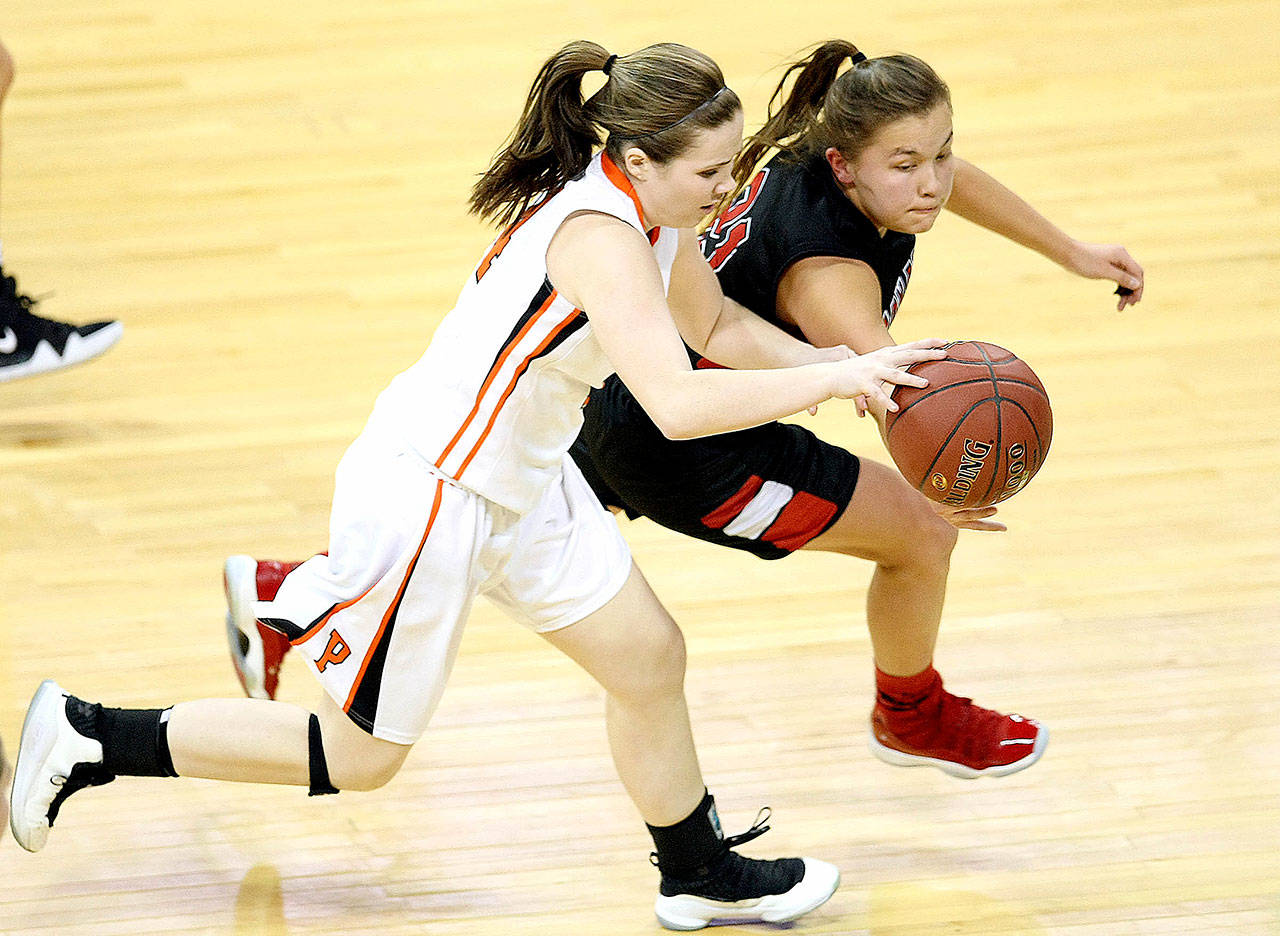 David Willoughby/for Peninsula Daily News Neah Bay’s Gina McCauley steals the ball from Pomeroy’s Sydney Smith during the WIAA 1B girls semifinals at the Spokane Arena in Spokane.