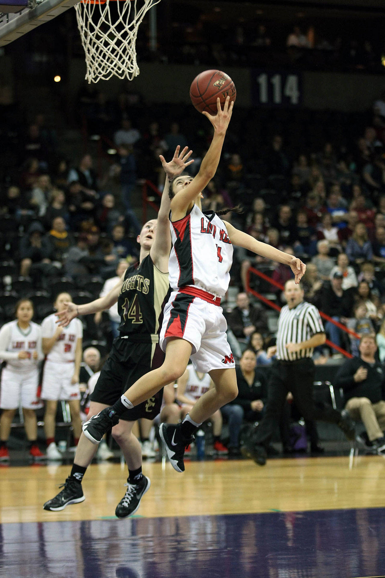 Neah Bays Lalia Greene dribbles baseline, beating Alyssa Martin from Sunnyside Christian with a reverse lay-up in Saturdays 1B third-place game. (David Willoughby/for Peninsula Daily News)