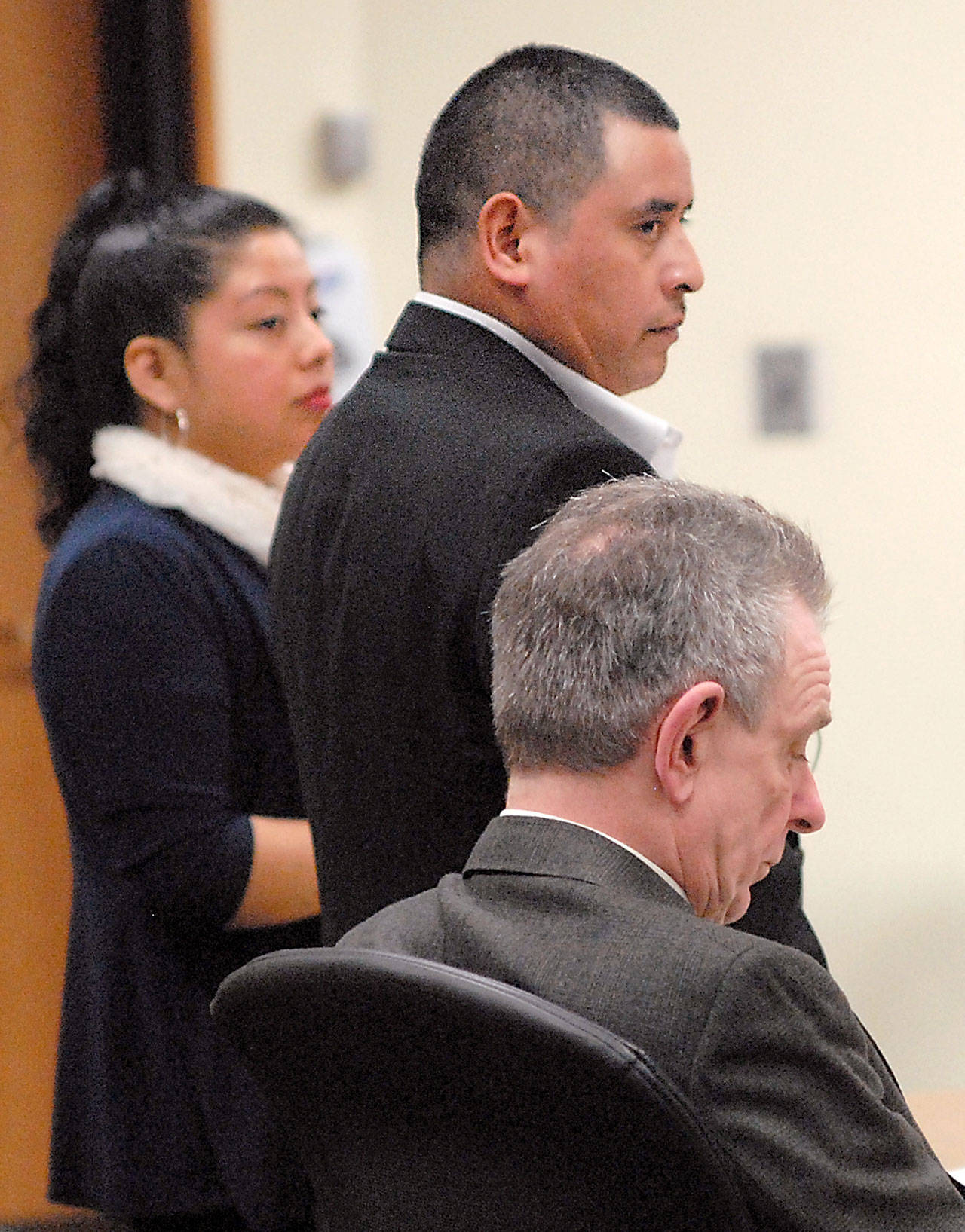 Martin Perez stands in Clallam County Superior Court during his rape trial Thursday. He is flanked by interpreter Bertilda Mendoza and defense attorney John Hayden. The trial resulted in a hung jury. (Keith Thorpe/Peninsula Daily News)