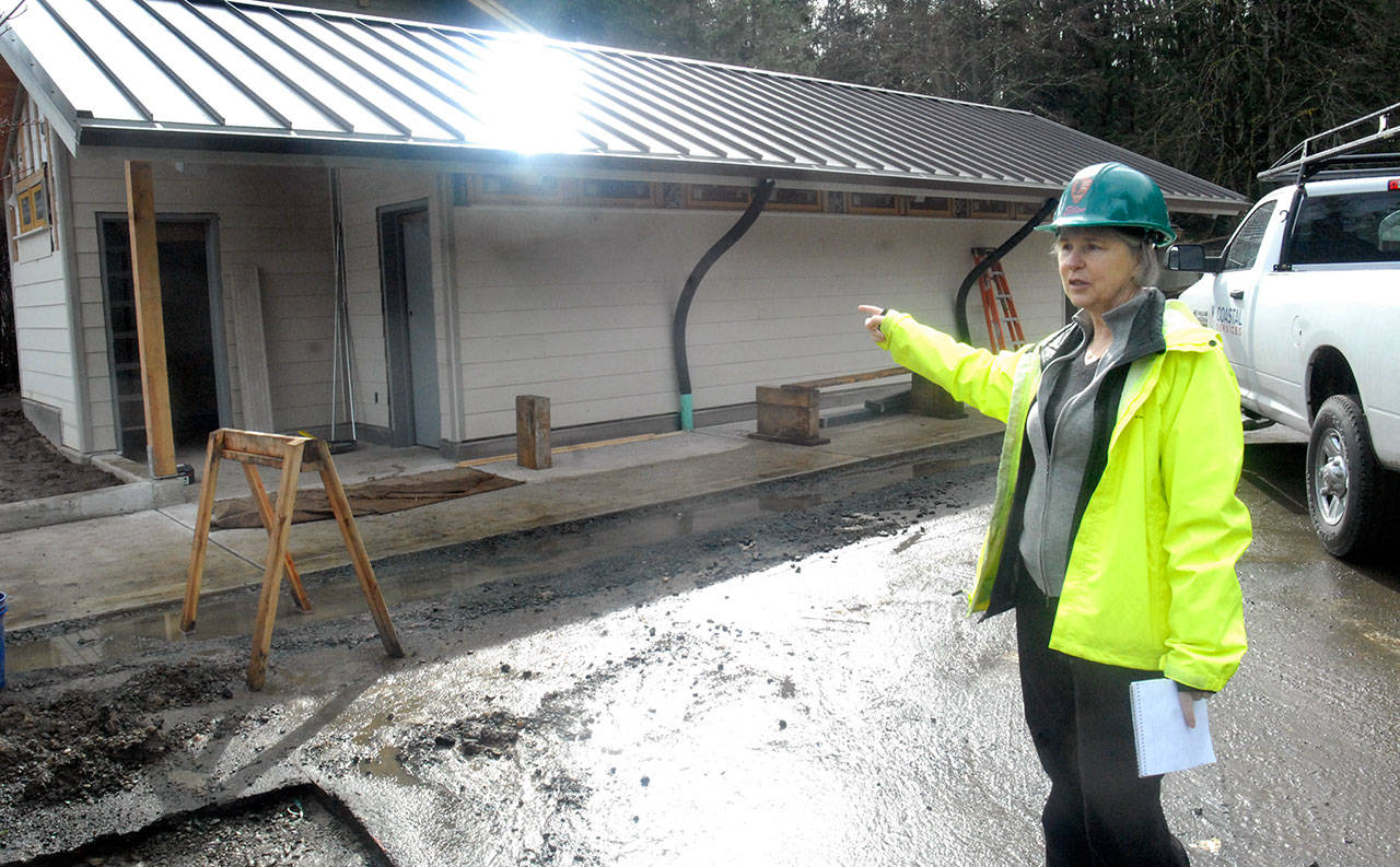 Historical architect Ellen Gage points out a new set of restrooms built near the parking area at the Olympic National Park visitor center in Port Angeles on Thursday. (Keith Thorpe/Peninsula Daily News)