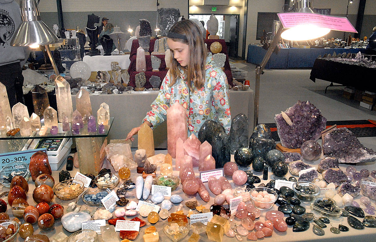 Ella Desser, 8, of Port Angeles examines a display of rocks and polished crystals during last year’s Rock, Gem and Jewelry Show at Vern Burton Community Center in Port Angeles. (Keith Thorpe/Peninsula Daily News)