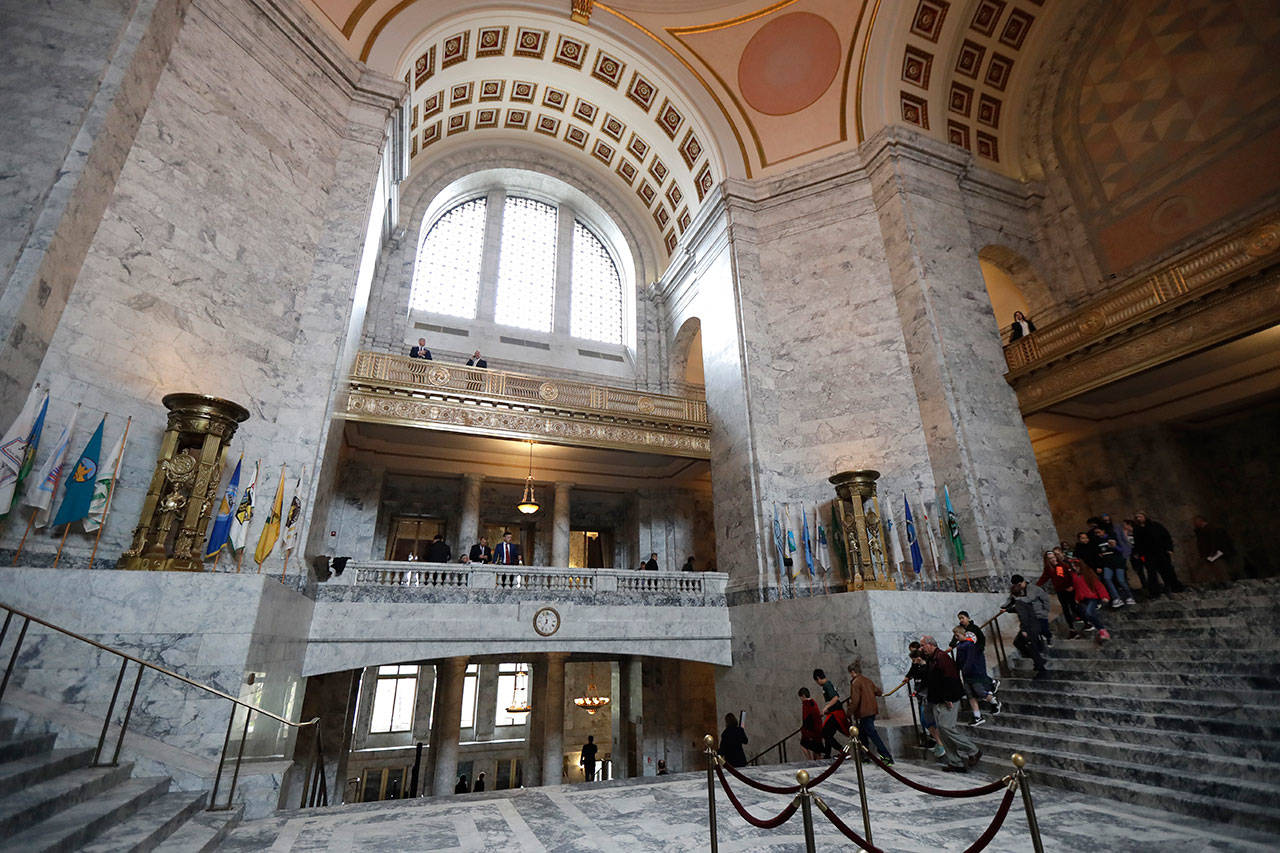 A school group walks down the steps of the Capitol Rotunda on Thursday at the Capitol in Olympia on the final day of the regular session of the Legislature. (Ted S. Warren/The Associated Press)
