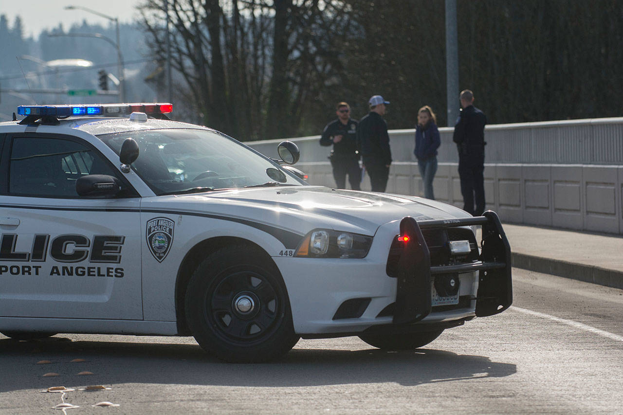 Police talk to witnesses after a reported suicide from the eastern Eighth Street bridge in Port Angeles on Monday. (Jesse Major/Peninsula Daily News)