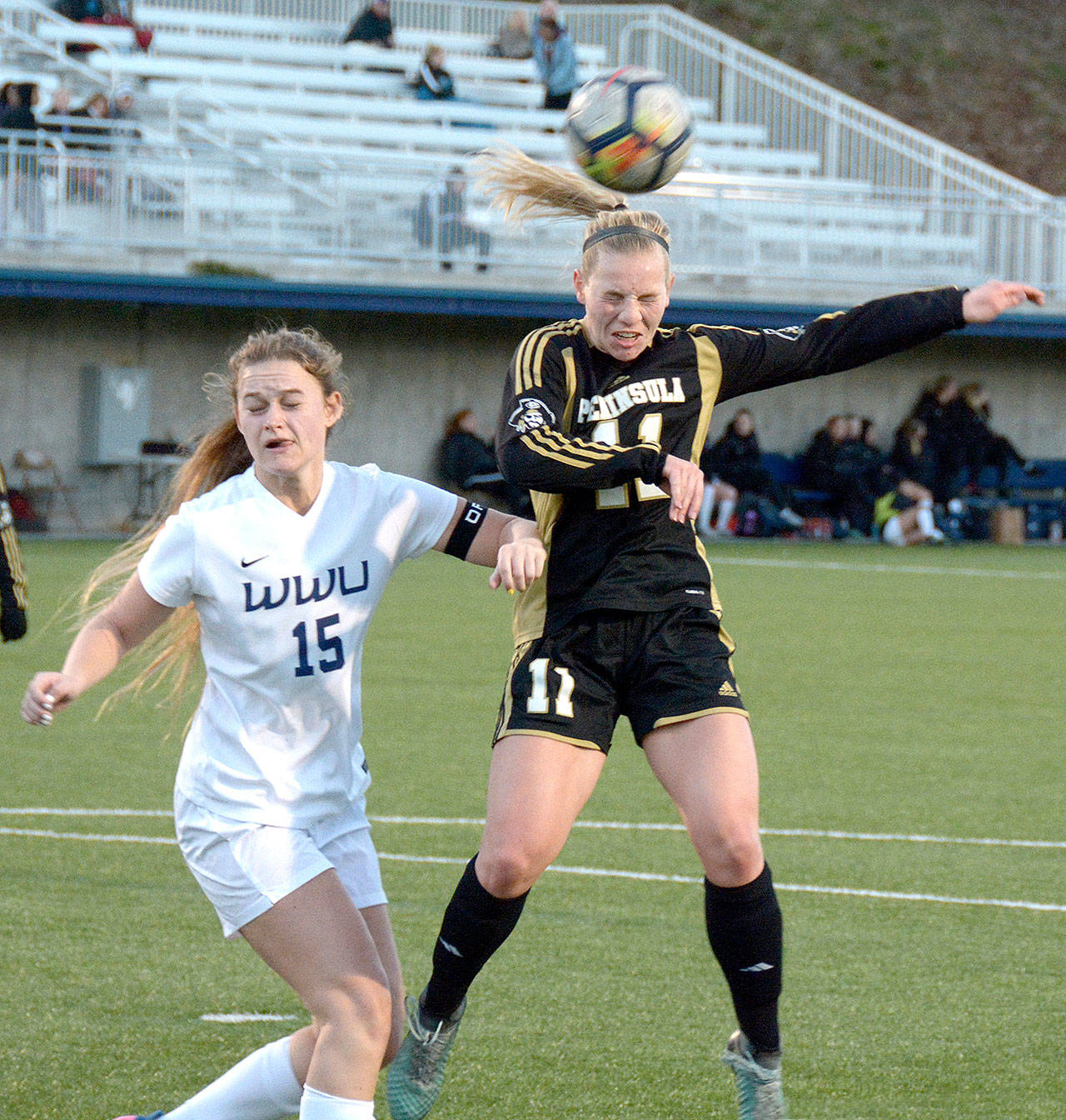 Peninsulas Maddy Parton, guarded by Western Washingtons Sophia Kallas, heads the ball in a friendly match Saturday in Bellingham. Peninsula won the match 2-0. (Rick Ross)