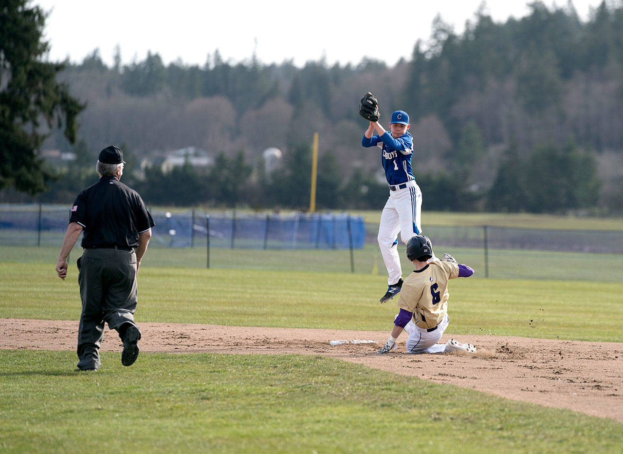Steve Mullensky/for Peninsula Daily News Sequim’s Ian Miller slides safely into second on a steal during a game against Chimacum on Monday.