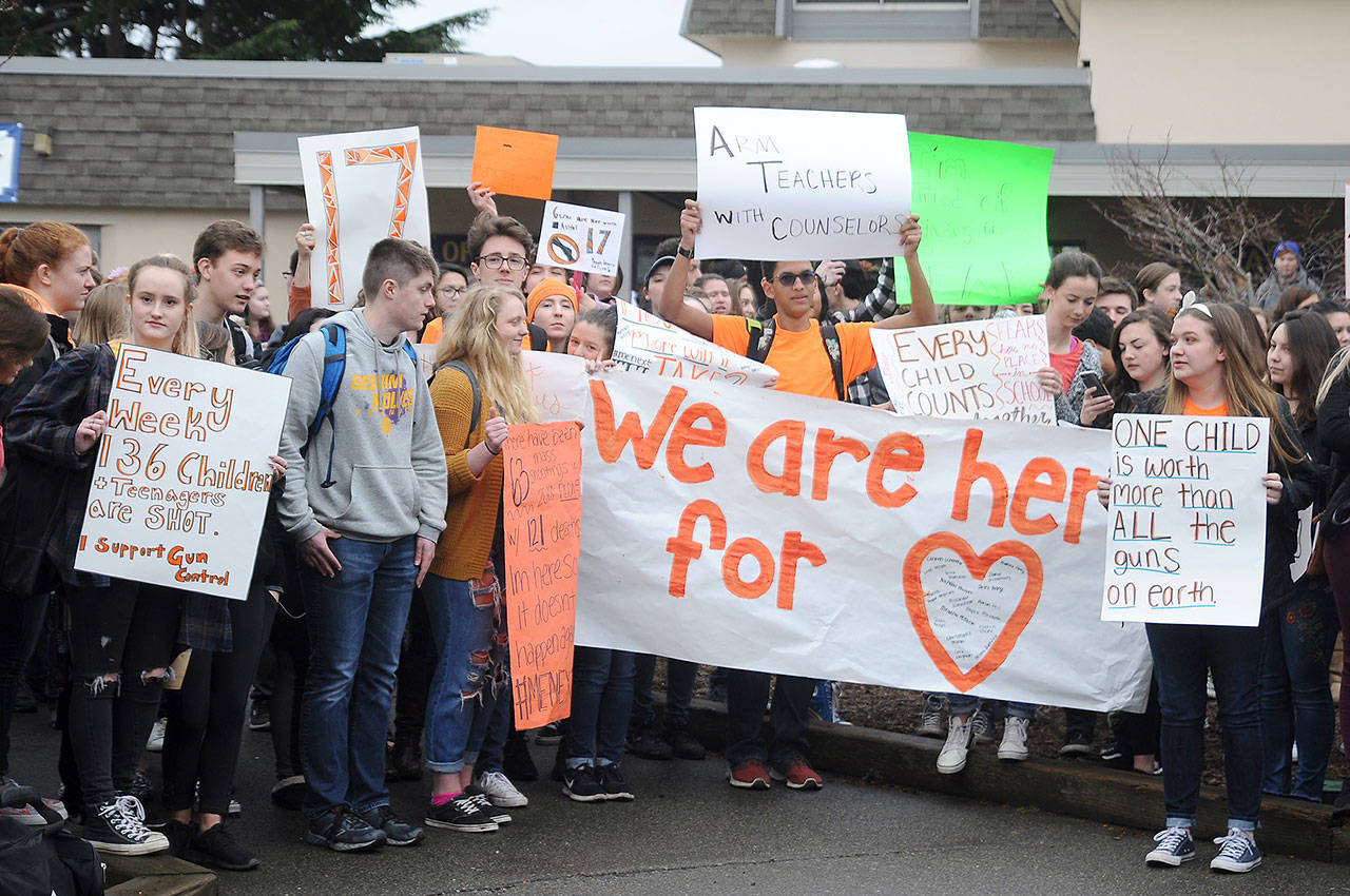 About 100 Sequim High School students take a break from classes to express their views about gun control laws during the National School Walkout on Wednesday. Along with students across the country, SHS students offered up a variety of views on the school campus at 10 a.m. for a 17-minute demonstration — one minute for each of the 17 people killed at Florida’s Marjory Stoneman Douglas High School one month ago. (Michael Dashiell/Olympic Peninsula News Group)