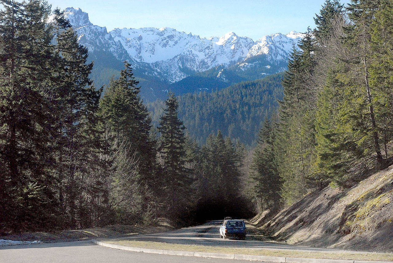 A car makes its way up Hurricane Ridge Road near Heart o’ the Hills south of Port Angeles. Snowpack in the Olympic Mountains was at 119 percent of normal for the final days of winter. (Keith Thorpe/Peninsula Daily News)