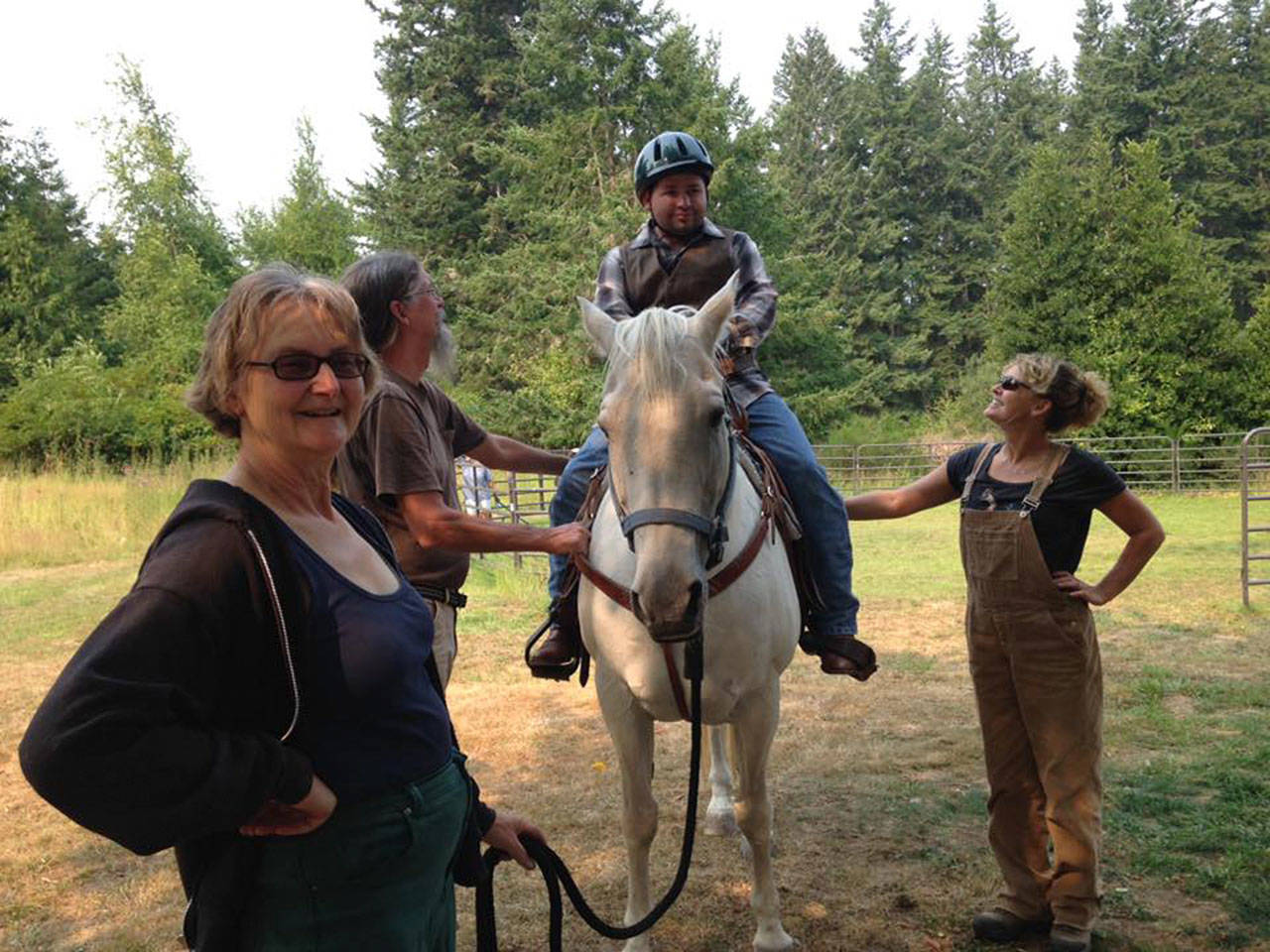 Garet Bonham, a Sequim resident and Special Olympics athlete, rides the trails during summer camp at Camp Beausite NW, thanks to volunteers and horses from the Buckhorn Chapter of Backcountry Horsemen. (Camp Beausite NW)