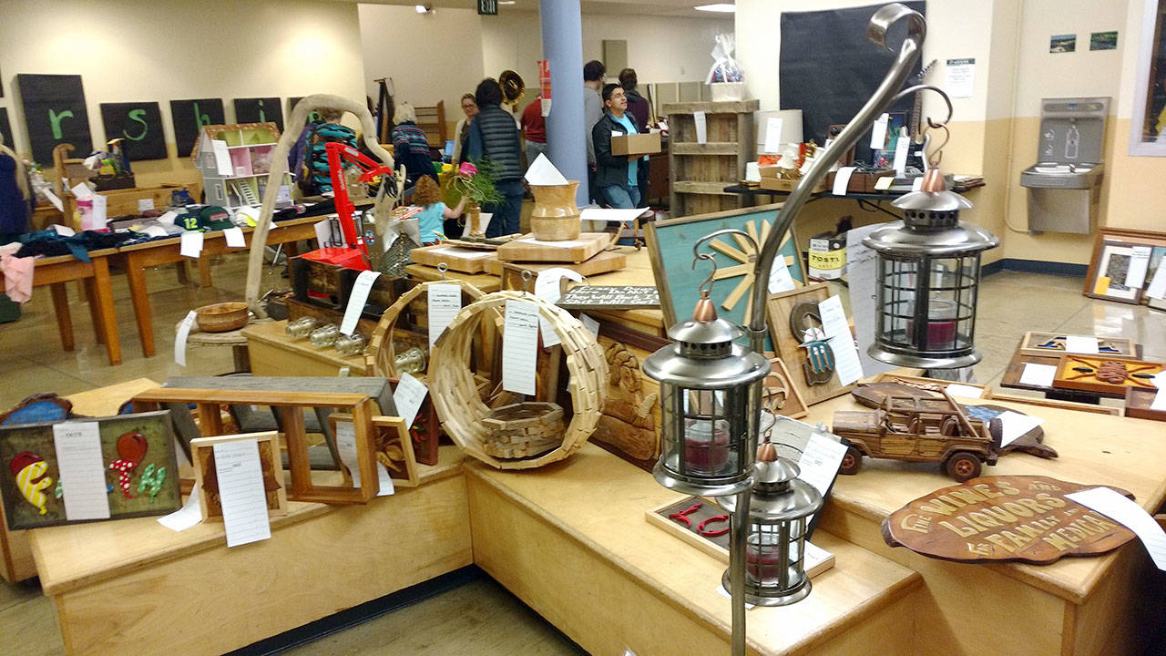 West End folks came to participate in the Quillayute Valley Scholarship Auction. Items are displayed in the staging area on shelves for viewing before the action in the auditorium. (Zorina Barker/for Peninsula Daily News)