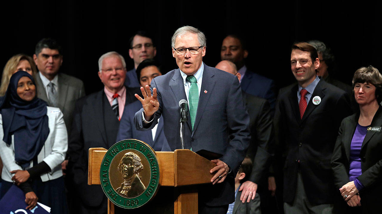 Gov. Jay Inslee speaks before signing bills aimed at increasing voter access Monday in Tukwila. Among the bills was a measure to preregister 16 and 17 year olds so that they can vote as soon as they turn 18. (Elaine Thompson/The Associated Press)