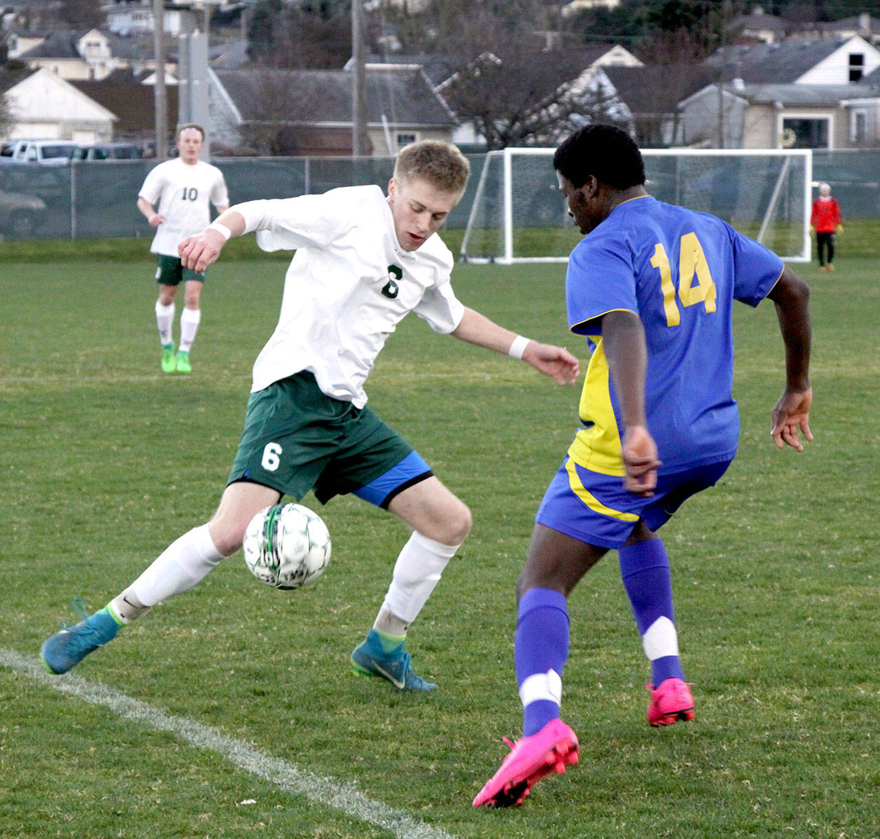 Port Angeles’s Ben Schneider fights to control the ball along the sidelines while Bremerton’s Philip Curtis tries to defend in Monday’s game at Civic Field. (Dave Logan/for Peninsula Daily News)