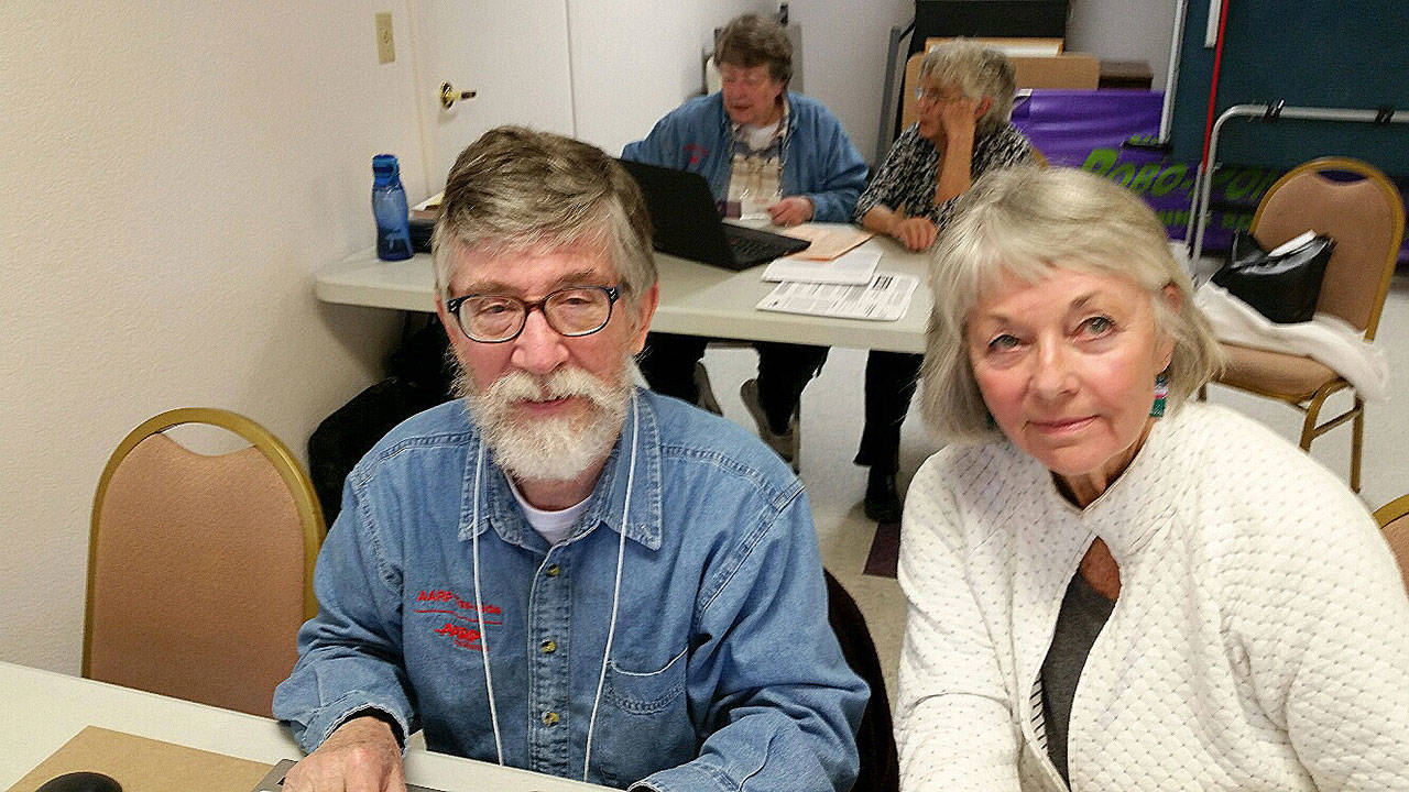 IRS-certified Tax-Aide volunteer Severne Johnson assists taxpayer Janette Finfrock at Shipley Center in Sequim.