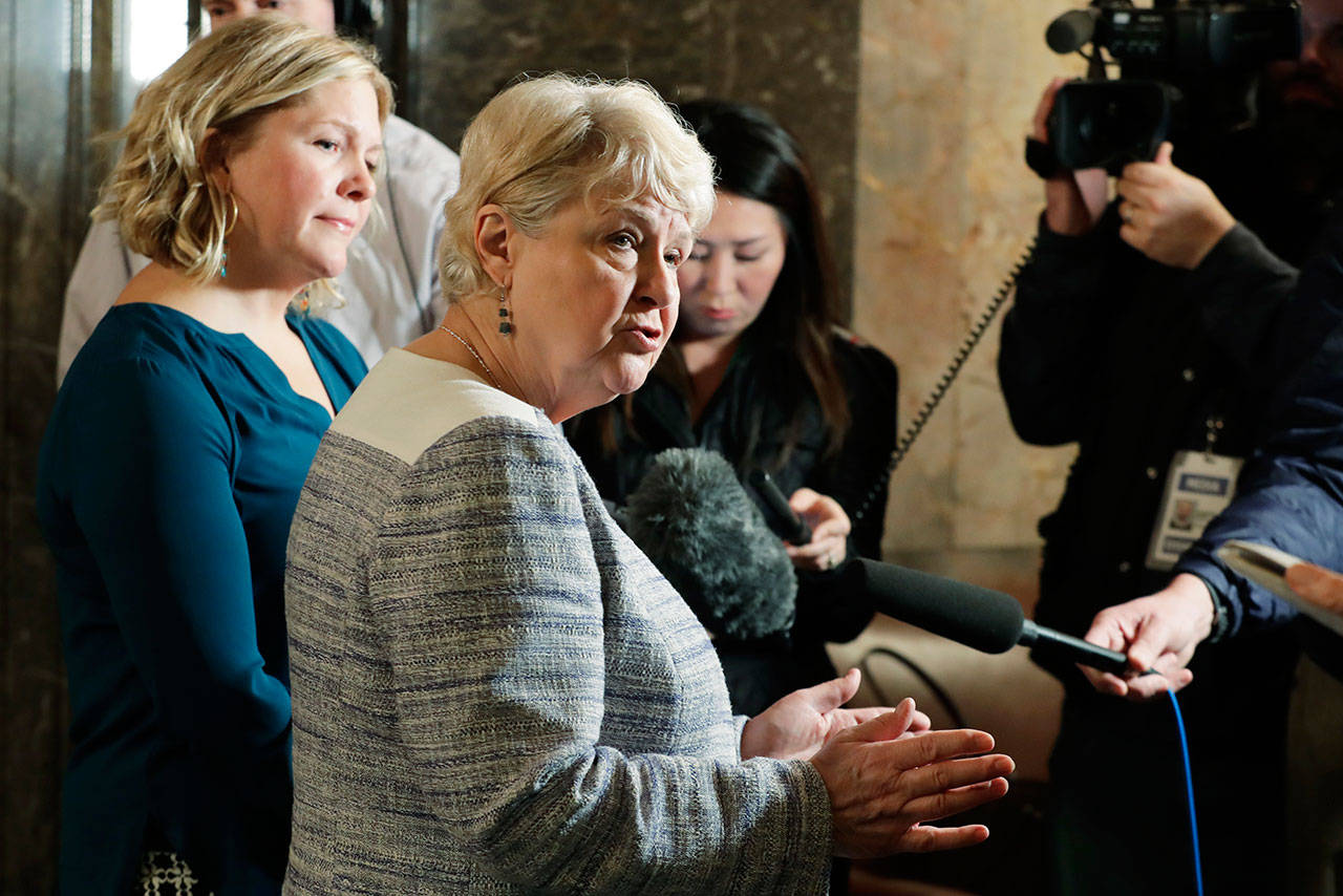 State Sen. Karen Keiser, D-Des Moines, center, talks to reporters Wednesday at the Capitol in Olympia after Gov. Jay Inslee signed a package of bills meant to address sexual misconduct at the workplace in the wake of a national conversation about sexual harassment sparked by the #MeToo movement. Keiser sponsored three of the measures. (Ted S. Warren/The Associated Press)